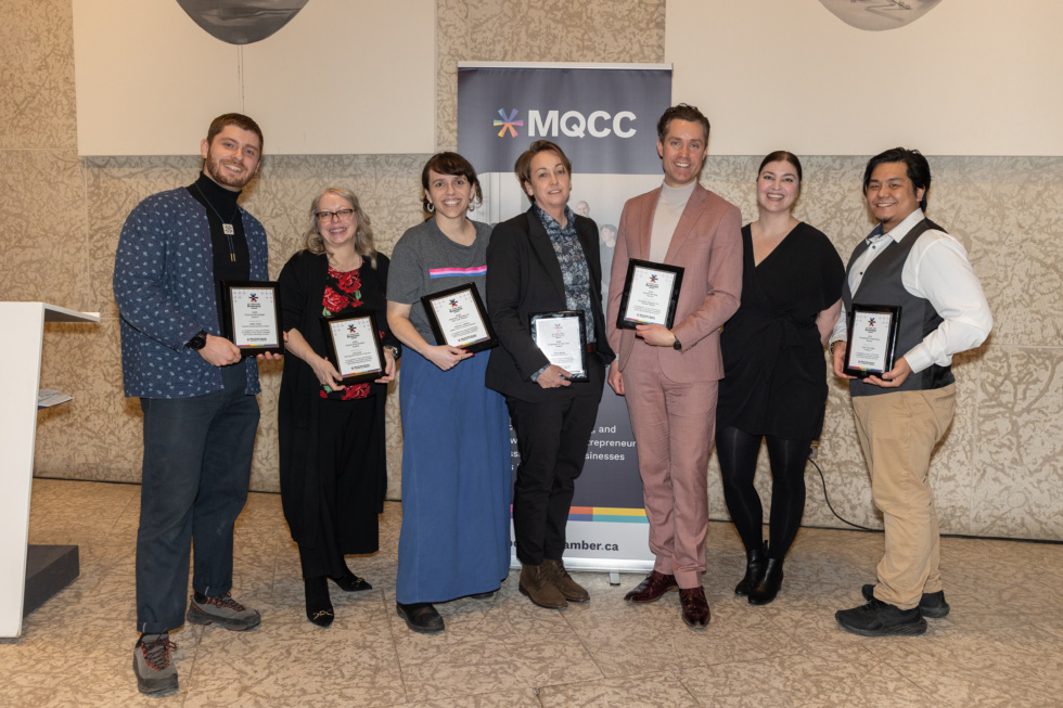 Winners of the 2026 MQCC business awards, standing in a row and smiling while holding the plaques awarded to them