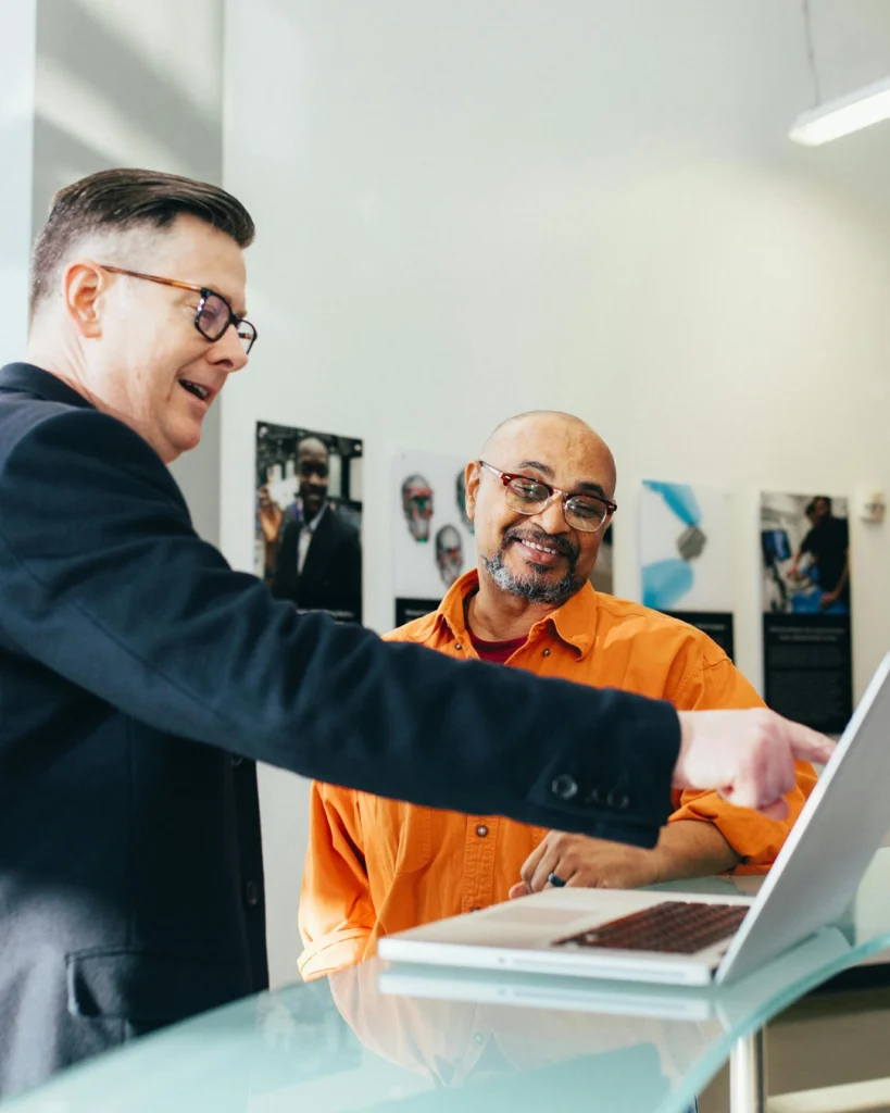Two people looking at a laptop together